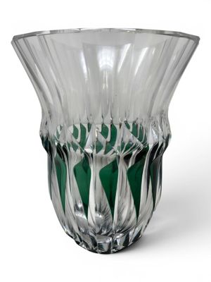 a glass vase that is sitting on a white surface