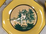 several yellow plates with a picture of a castle on them