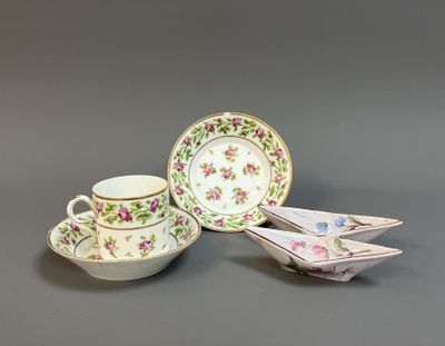 two cups and saucers sitting on top of each other on a table