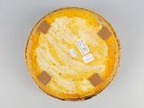an image of a yellow and brown bowl on a white surface