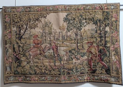 an image of a tapestry hanging on a wall with a picture of a man riding a horse