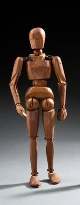 a wooden figure that is standing in the dark