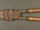 an old pair of pliers with leather handles on a table
