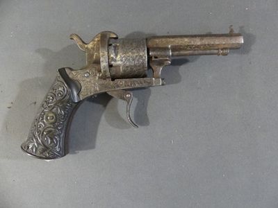 a silver revolver on a table with a black handle