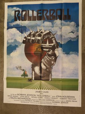 a poster for rollerball featuring a giant hand holding a giant head
