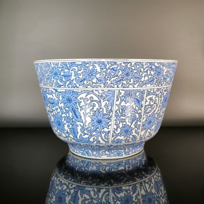 a blue and white bowl sitting on a black table