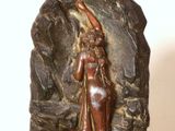 statue d'une femme dans une grotte, avec un rocher en arrière-plan