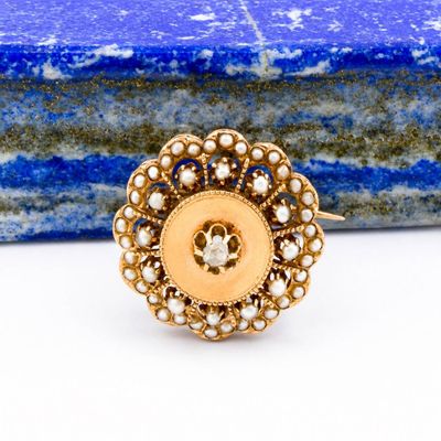 a close up of a gold ring with pearls on it