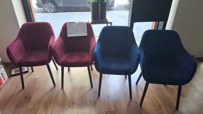 four chairs in a row in front of a window in a room