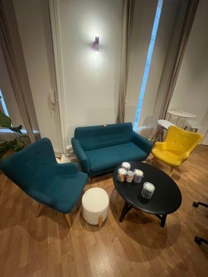 a living room with a couch, chair, table and coffee table