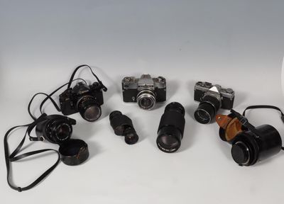 many different types of cameras sitting on a table