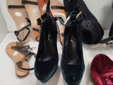 several pairs of women ' s shoes are lined up on a table