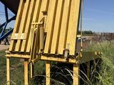 a yellow chair that is sitting in the grass