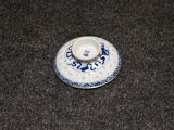 a small blue and white plate with a dragon on it