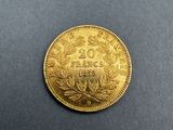 a gold coin on a black surface