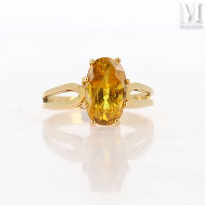 an image of a ring with a yellow sapphire stone on it