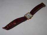 an image of a wrist watch with a red leather band