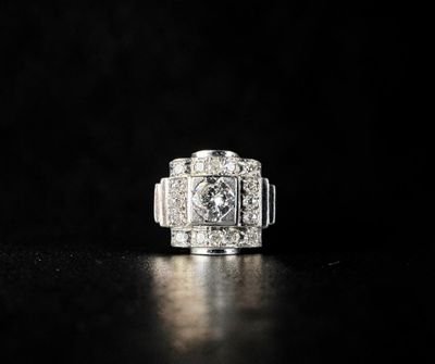 a close up of a diamond ring on a black surface