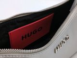 a silver purse with a red tag in it