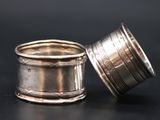 a silver cup sitting on a table next to a silver cup