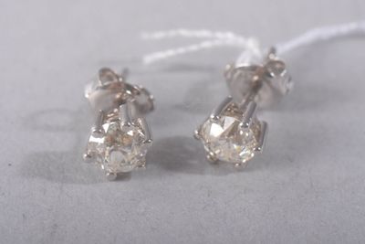 pair of diamond stud earrings on a white background
