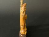 an image of a statue of a woman holding a staff