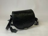 a black leather bag with a tassel hanging from it ' s side