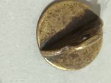 a close up of a metal button on a table