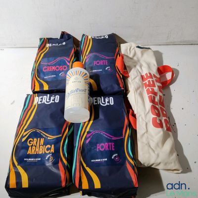 four bags of food and a bottle of water on a table