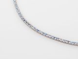 a blue and white diamond tennis necklace on a white surface