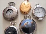 several different types of pocket watches are displayed on a table