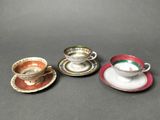 three cups and saucers are sitting on a table