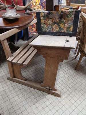 a small table and chairs in a room with a painting on the wall