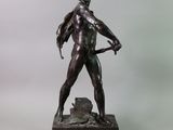 bronze statue of a man holding a bow and arrow on a marble base