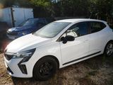 a white car that is parked in the grass