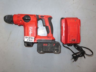 an image of a corded drill and a battery on a table