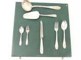 a green place mat with silverware and spoons on it