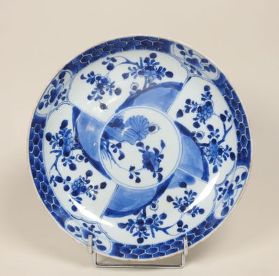 assiette bleue et blanche ornée d'un motif représentant un oiseau et une fleur