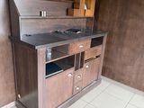 a small kitchen with a wooden cabinet and a sink