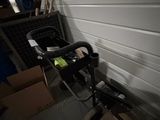 a bike that is parked in a garage next to a wall