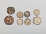 six different types of coins sitting on top of a white surface