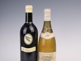 two bottles of wine sitting next to each other on a table