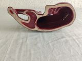 a small red and white bowl on a table