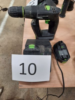 the corded drill is sitting on the table next to the corded drill