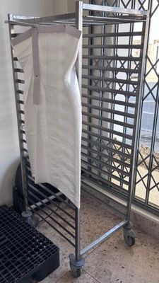 a towel rack with a towel hanging on it in front of a window