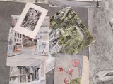 a bunch of drawings on the floor of a room