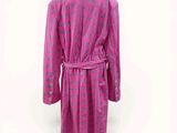 pink bathrobe with a pattern of cats on it on a mannequin stand