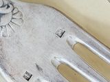 a fork and a spoon on a table with silverware