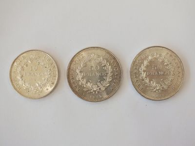 three different types of coins are shown on a white surface