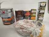 many cans of paint and cans of food on the counter